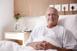 smiling older guy in hospital bed 1147975604 21Dec2020